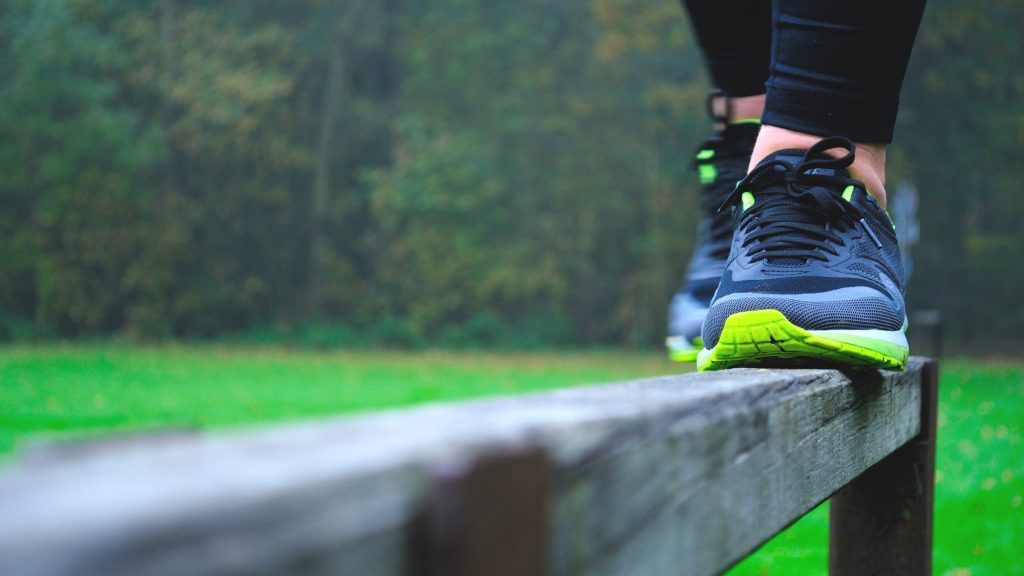 Balancing on a ledge railing to keep balance and fit healthy